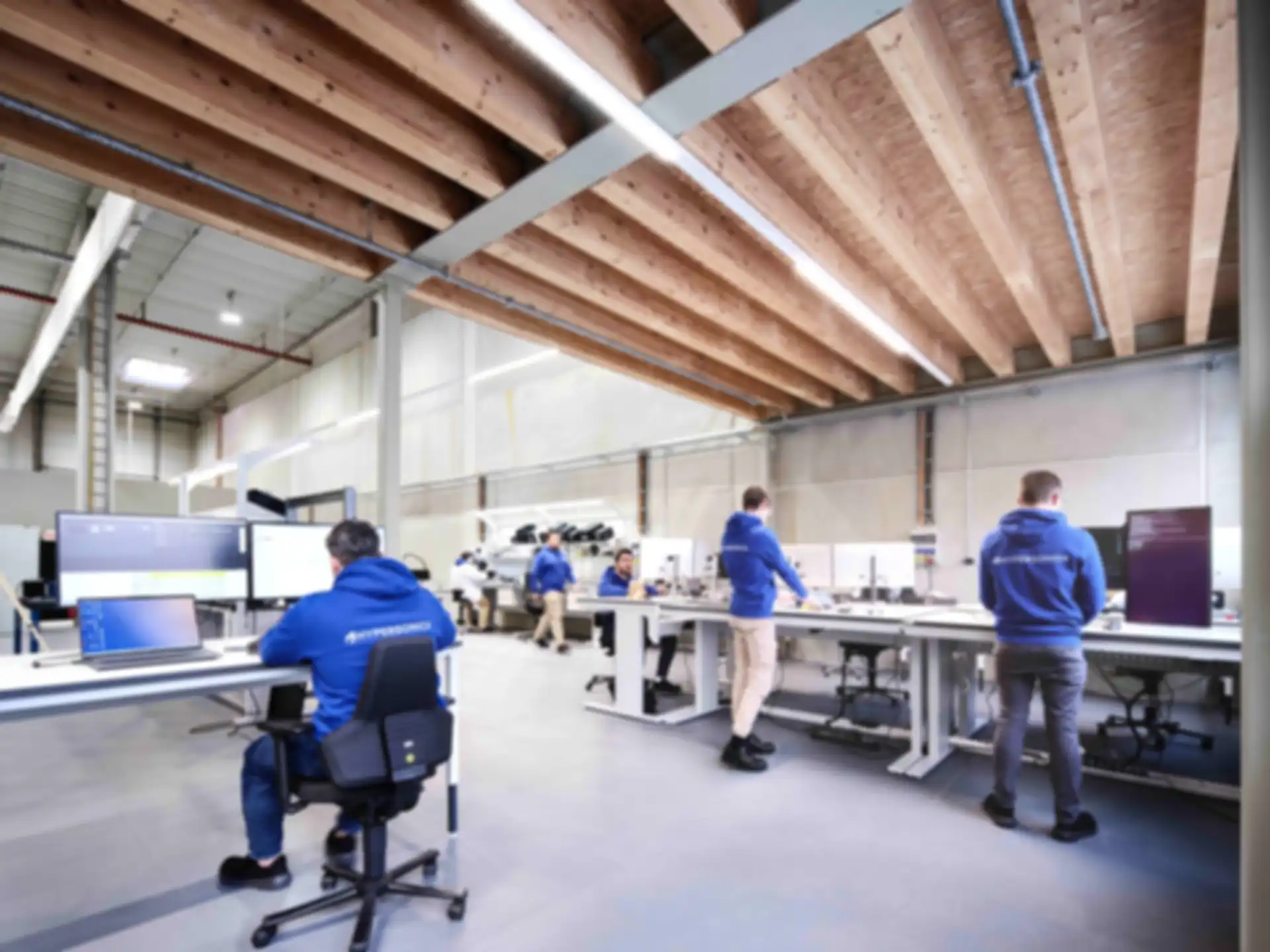 Several employees at work in the Hypersonica office.