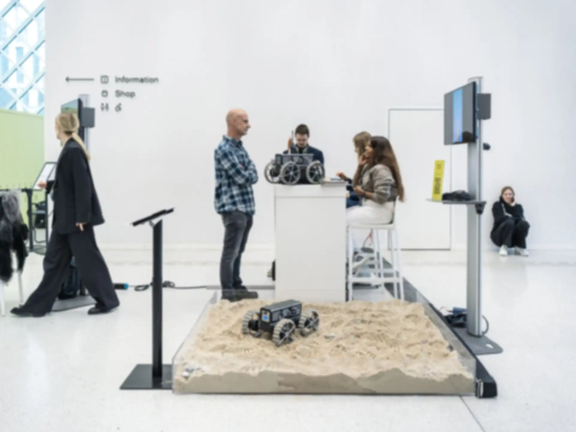 A four-person project team at their booth