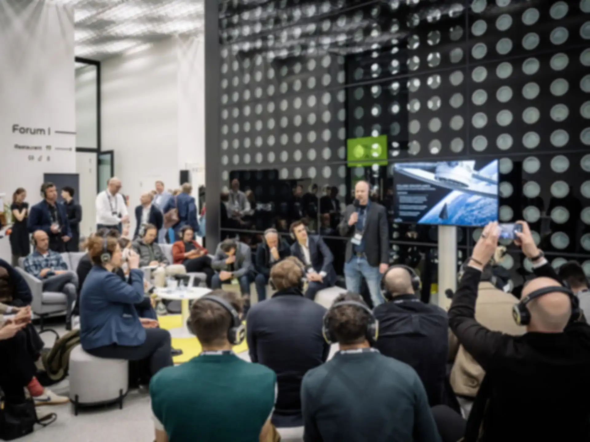 A person is giving a presentation surrounded by an audience