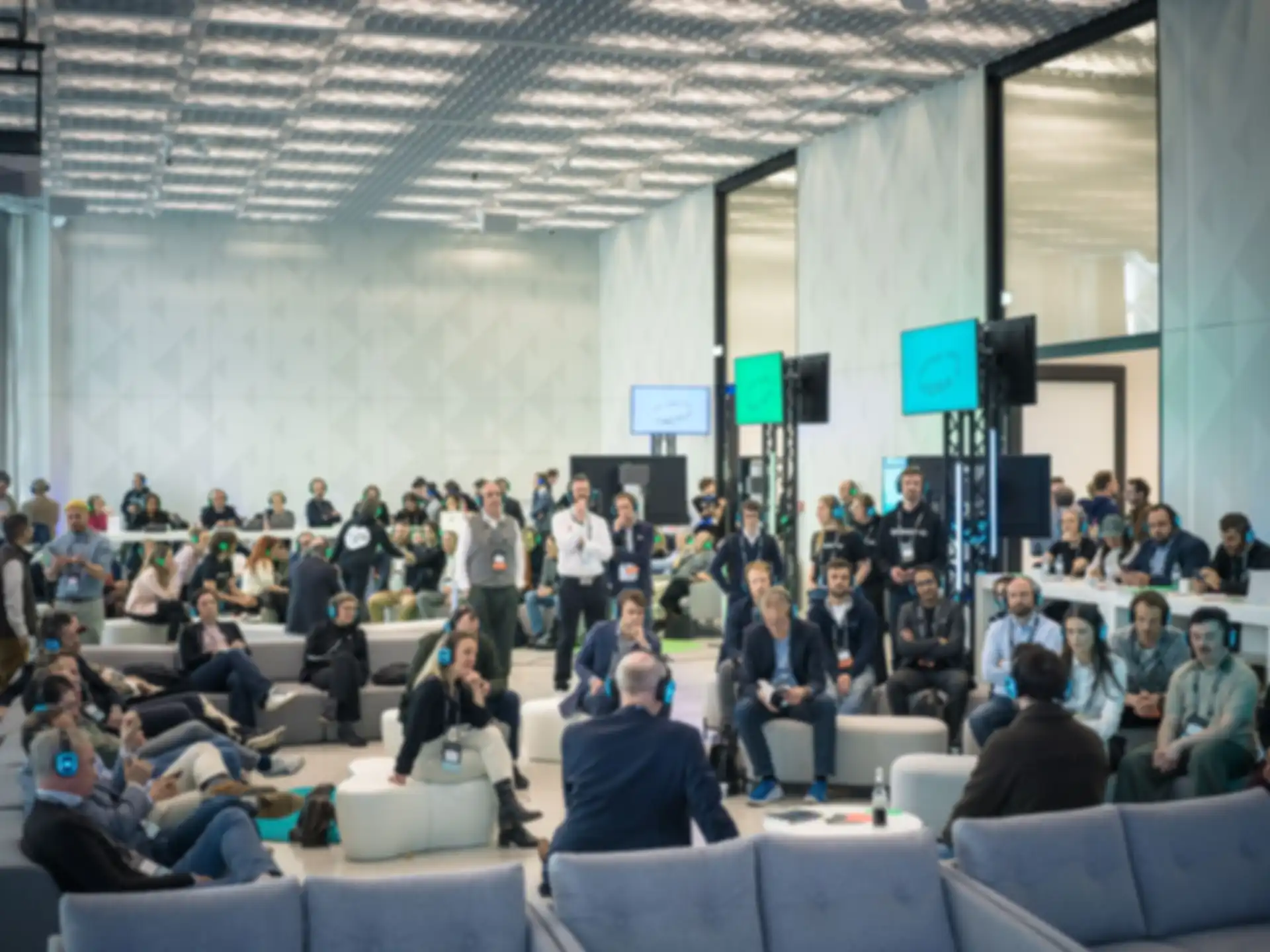 An overview of a room where various presentations are taking place at the same time