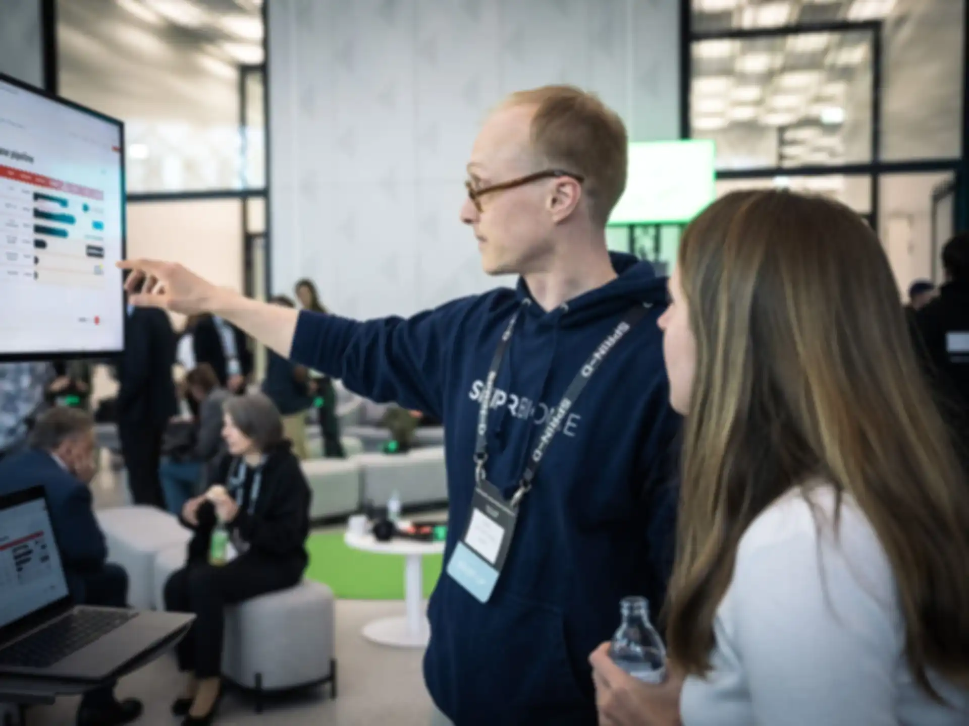 One person is presenting their project to another person using a screen