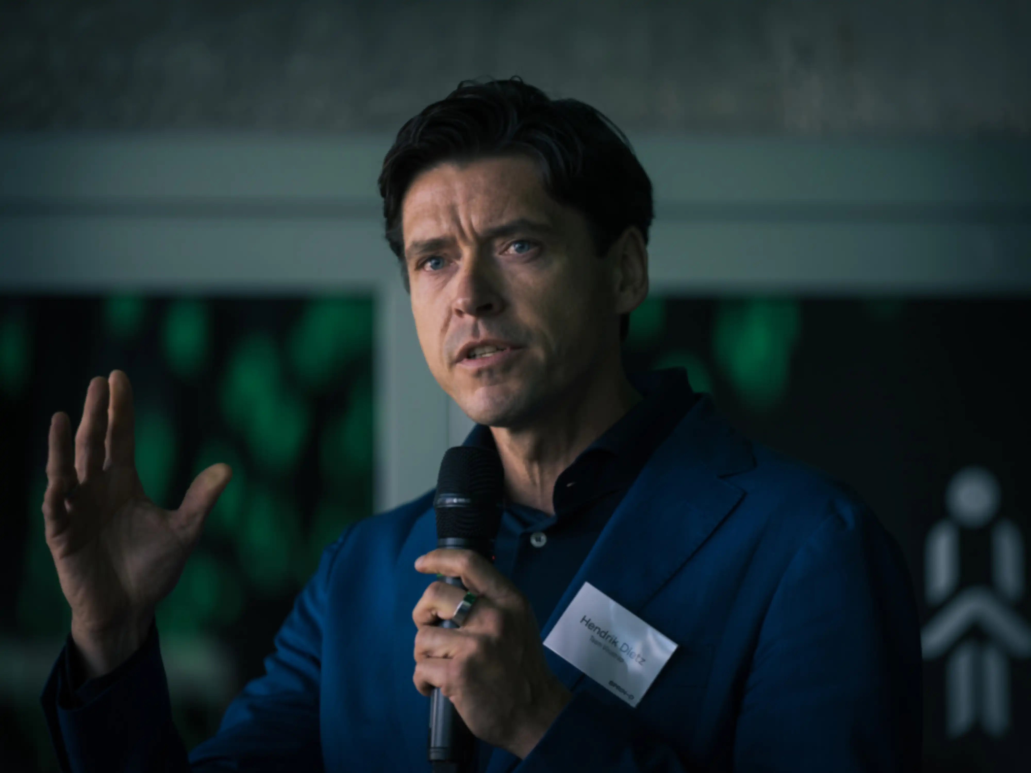 Close-up of a person giving a presentation, holding a microphone