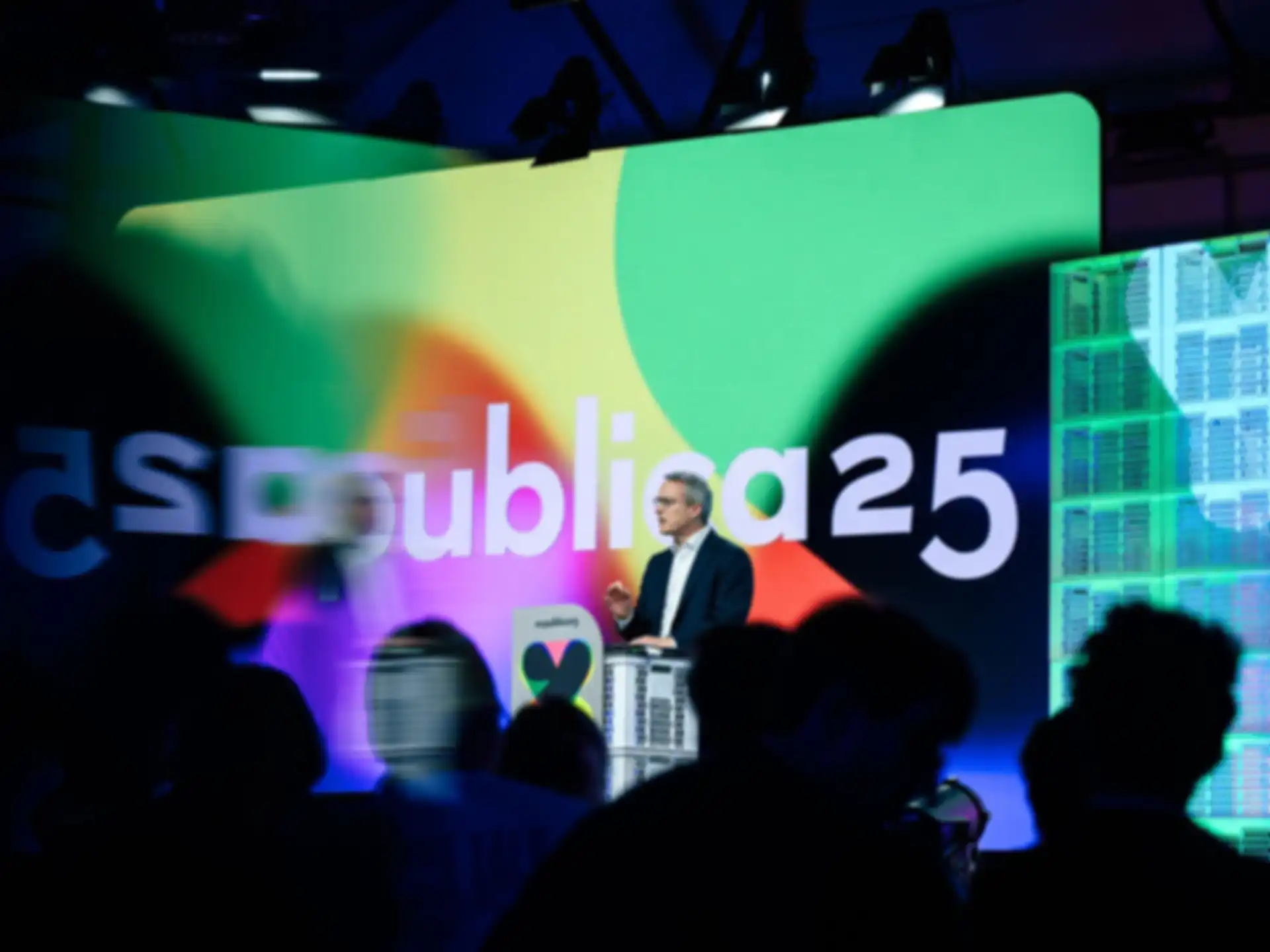 A person on stage is giving a presentation