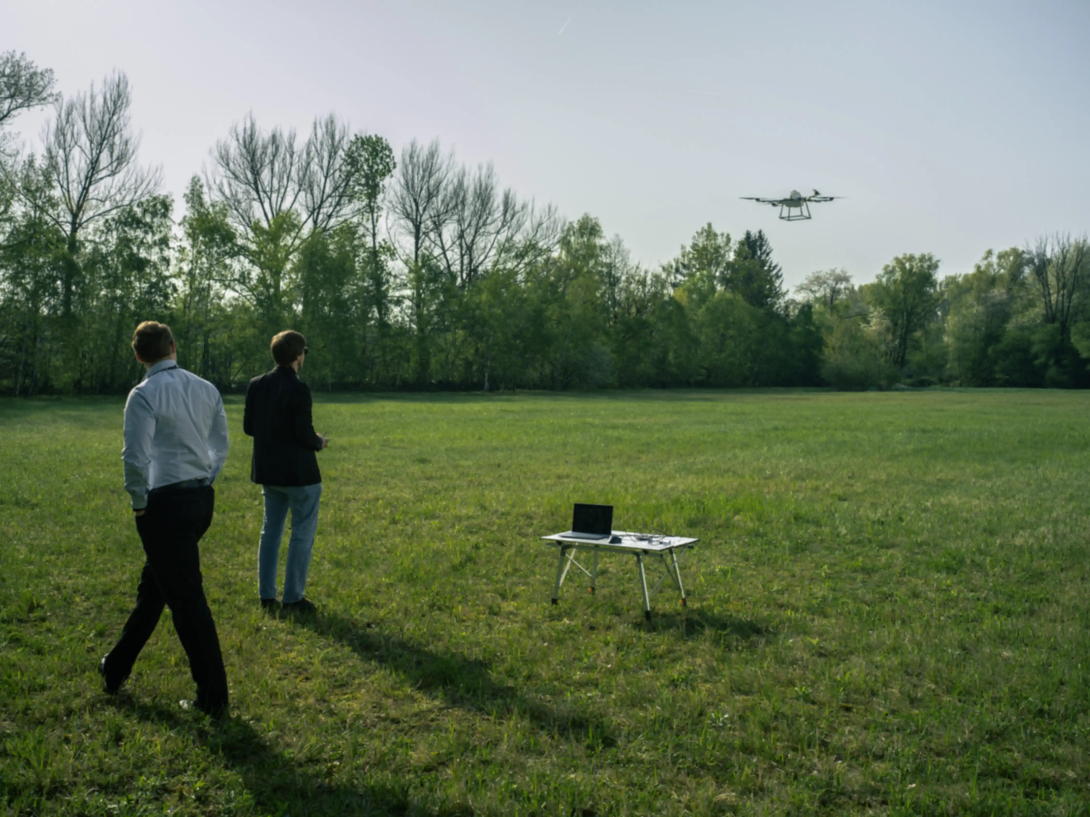 A team flies their drone over a field