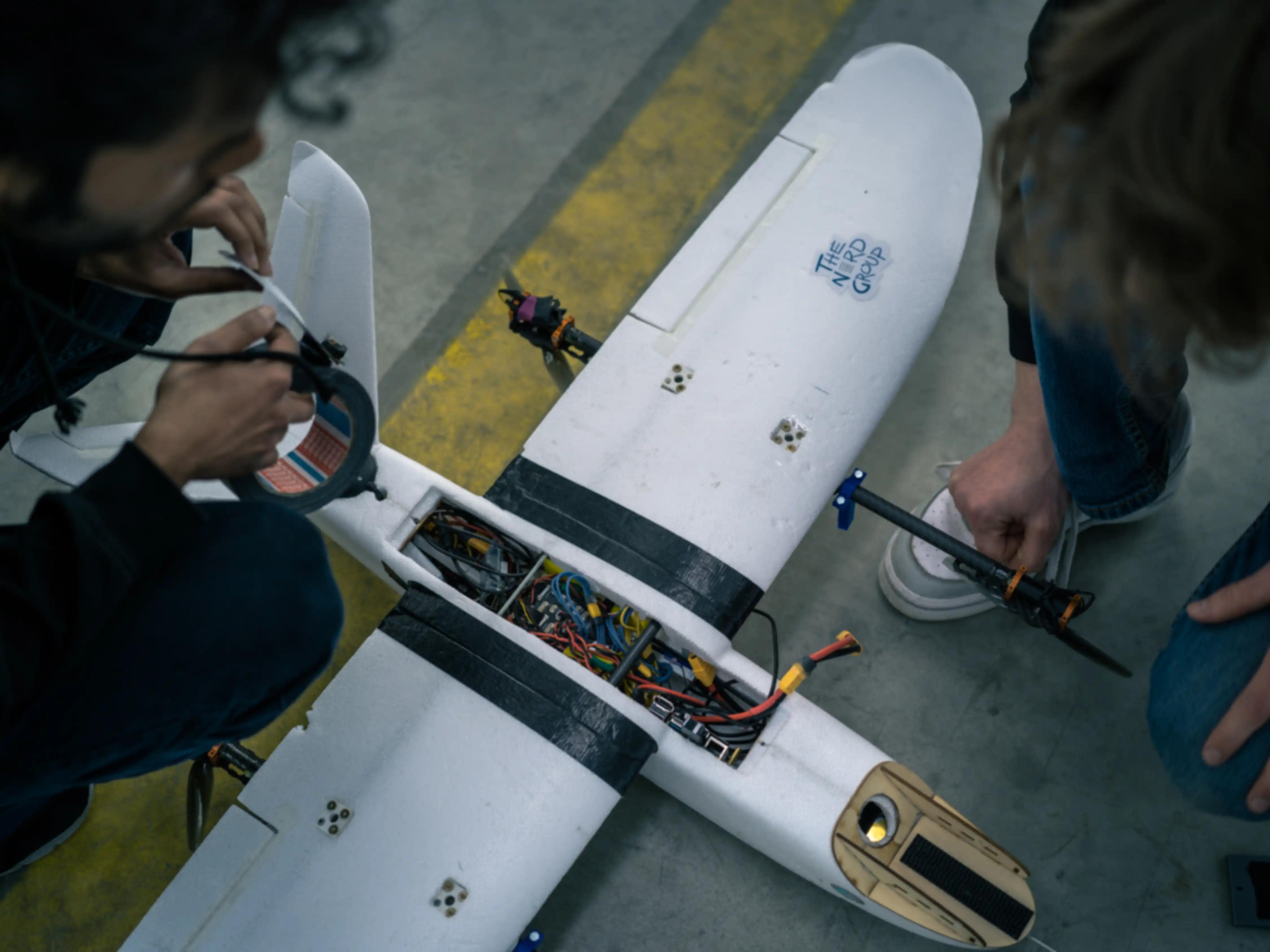 A team is repairing their drone