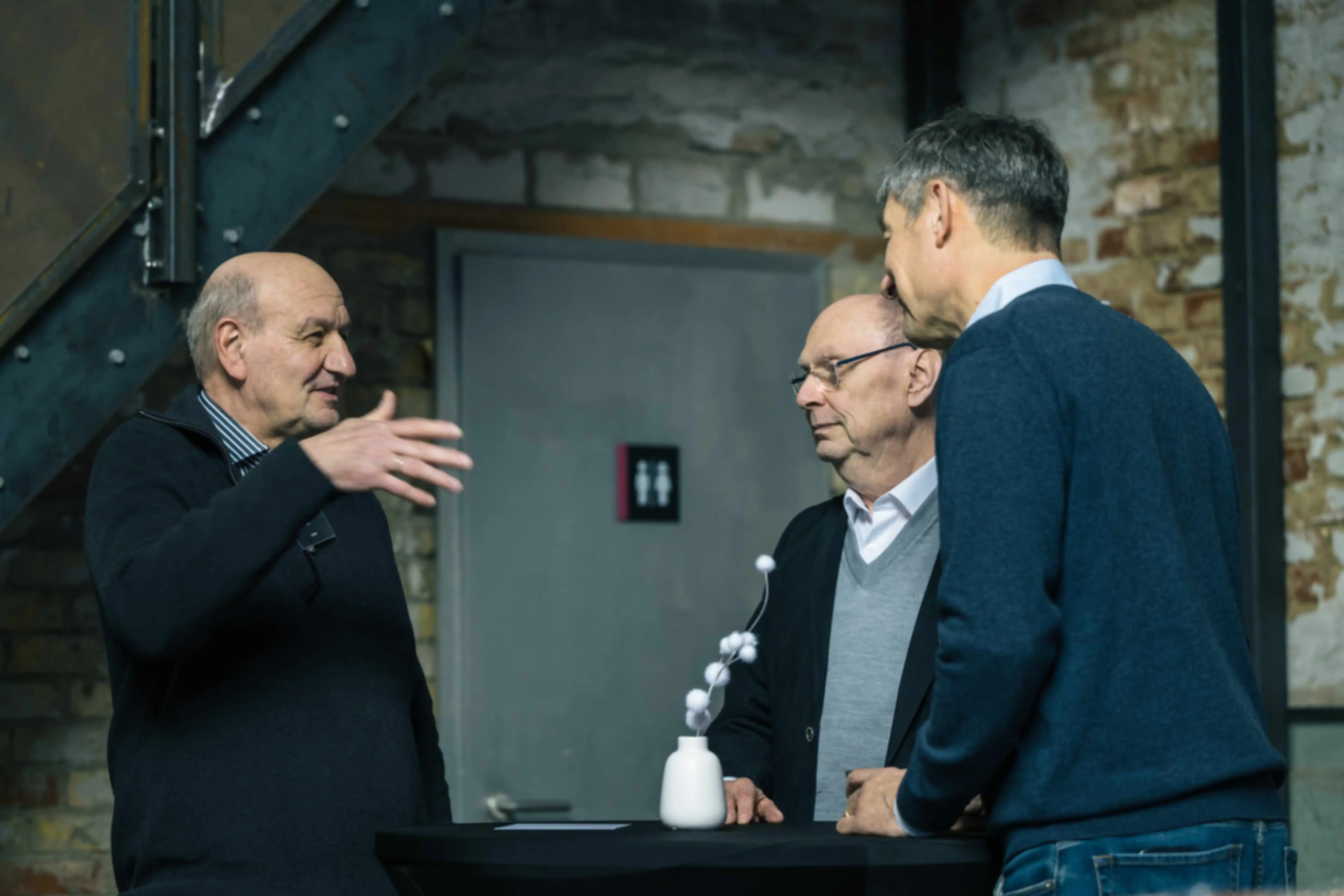 Three people in conversation