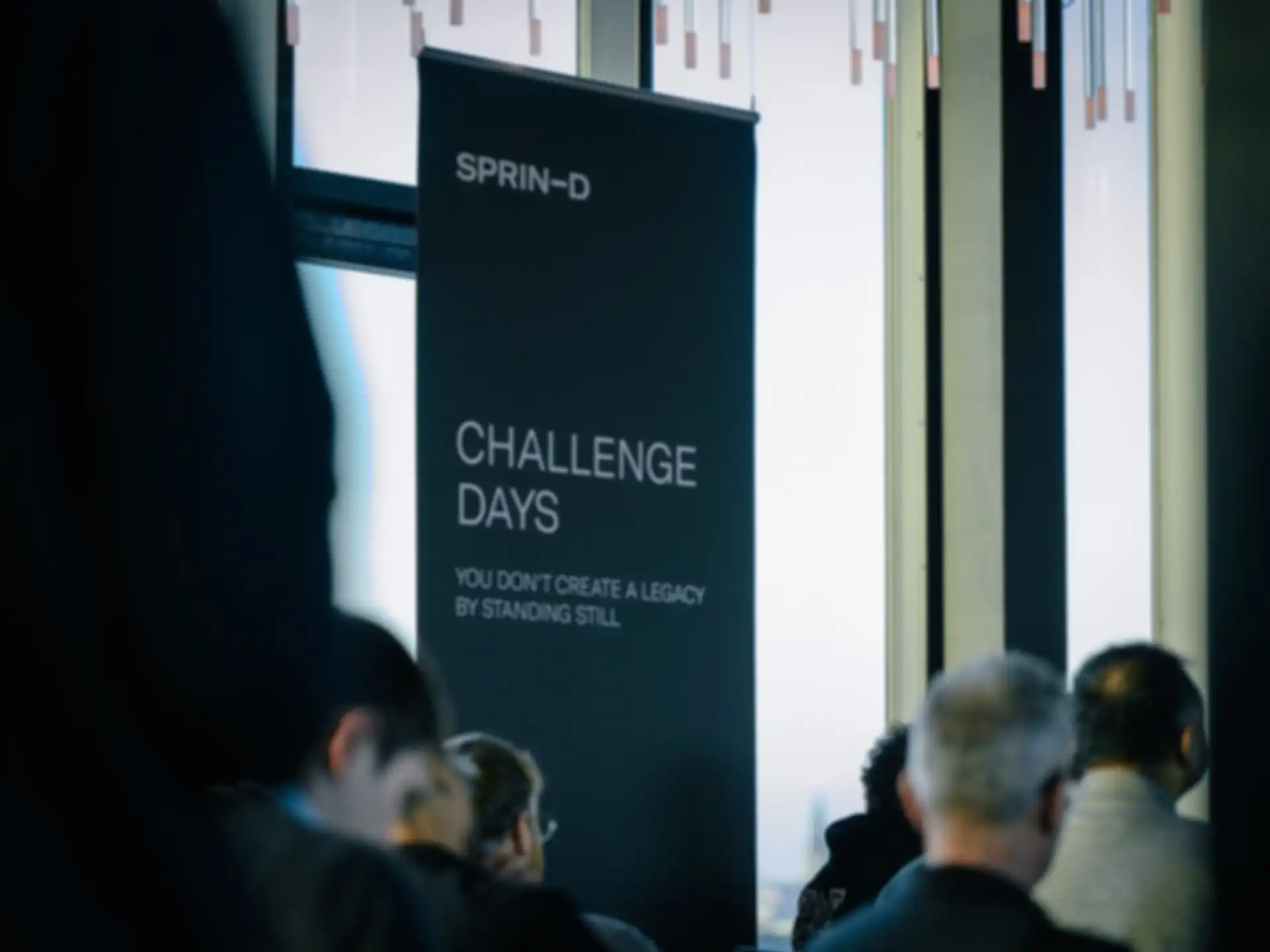 A banner reading "Challenge Days" next to the audience.