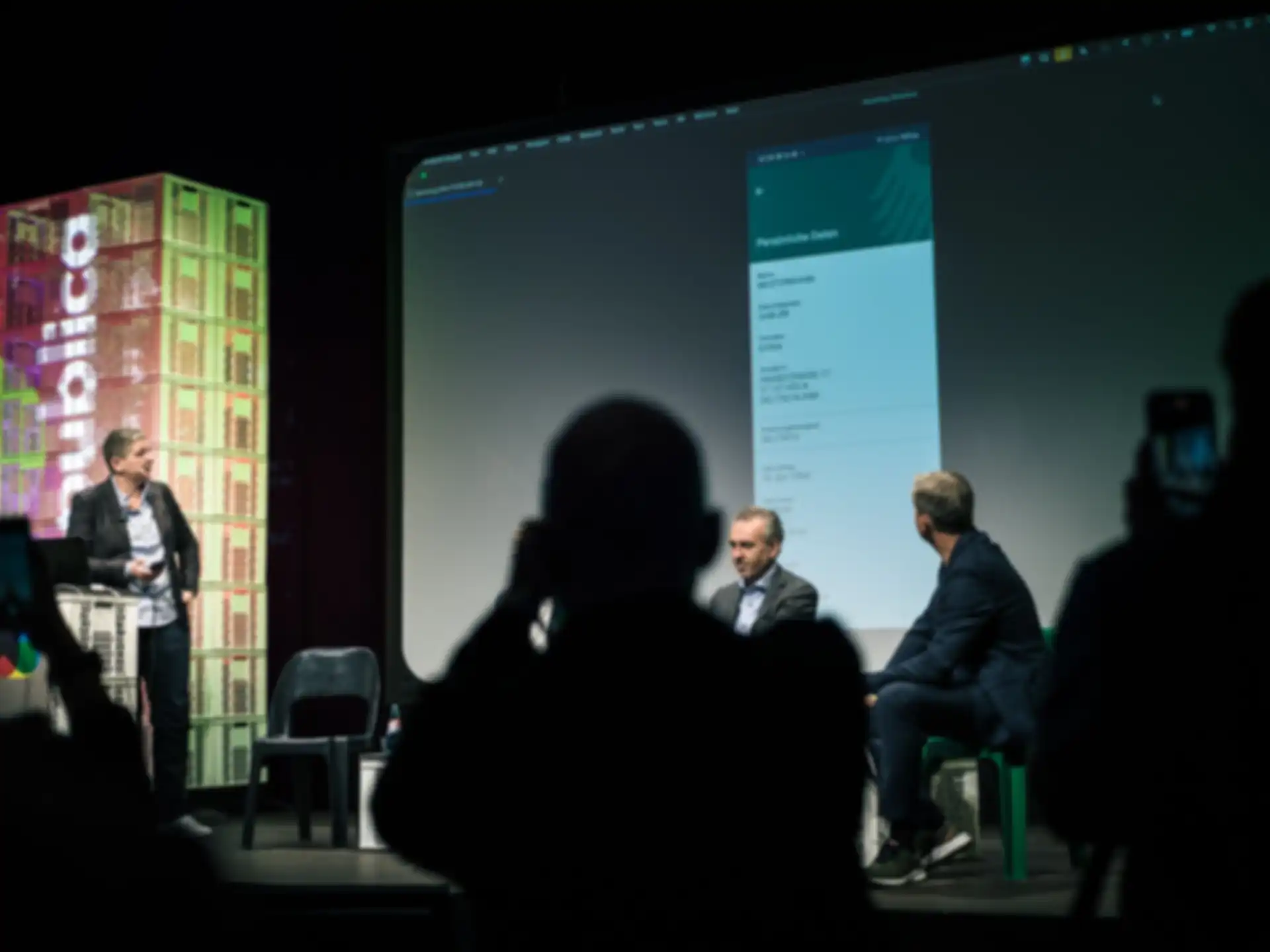 Four people on stage during a presentation