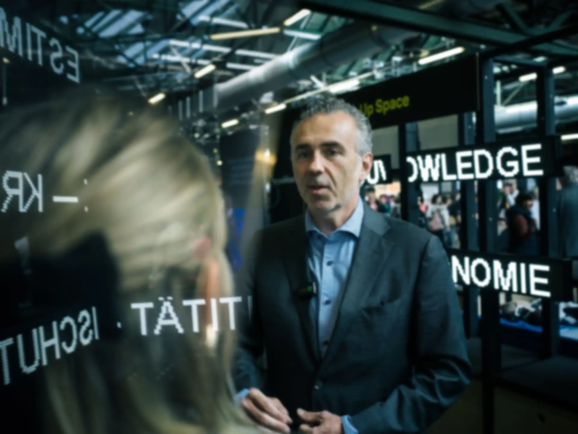 Two people talking at a fair booth