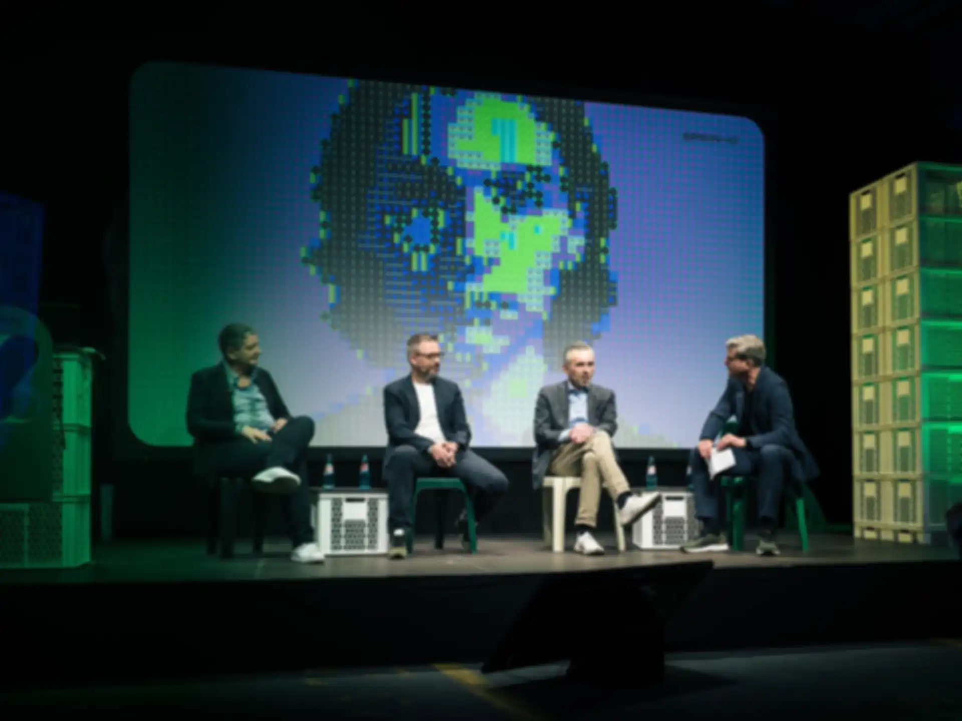 Four people on stage during a presentation