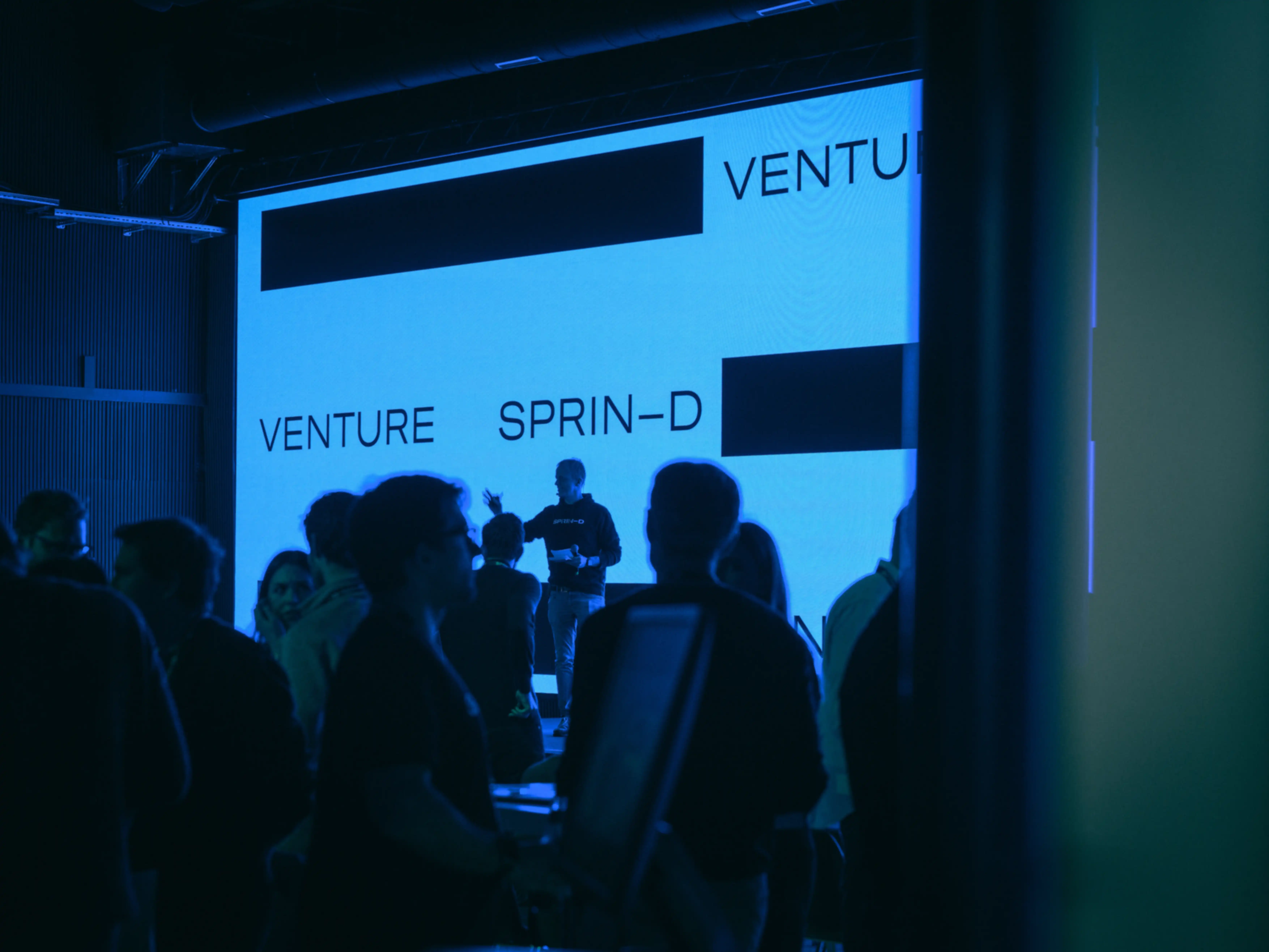 People in front of a stage with an LED wall