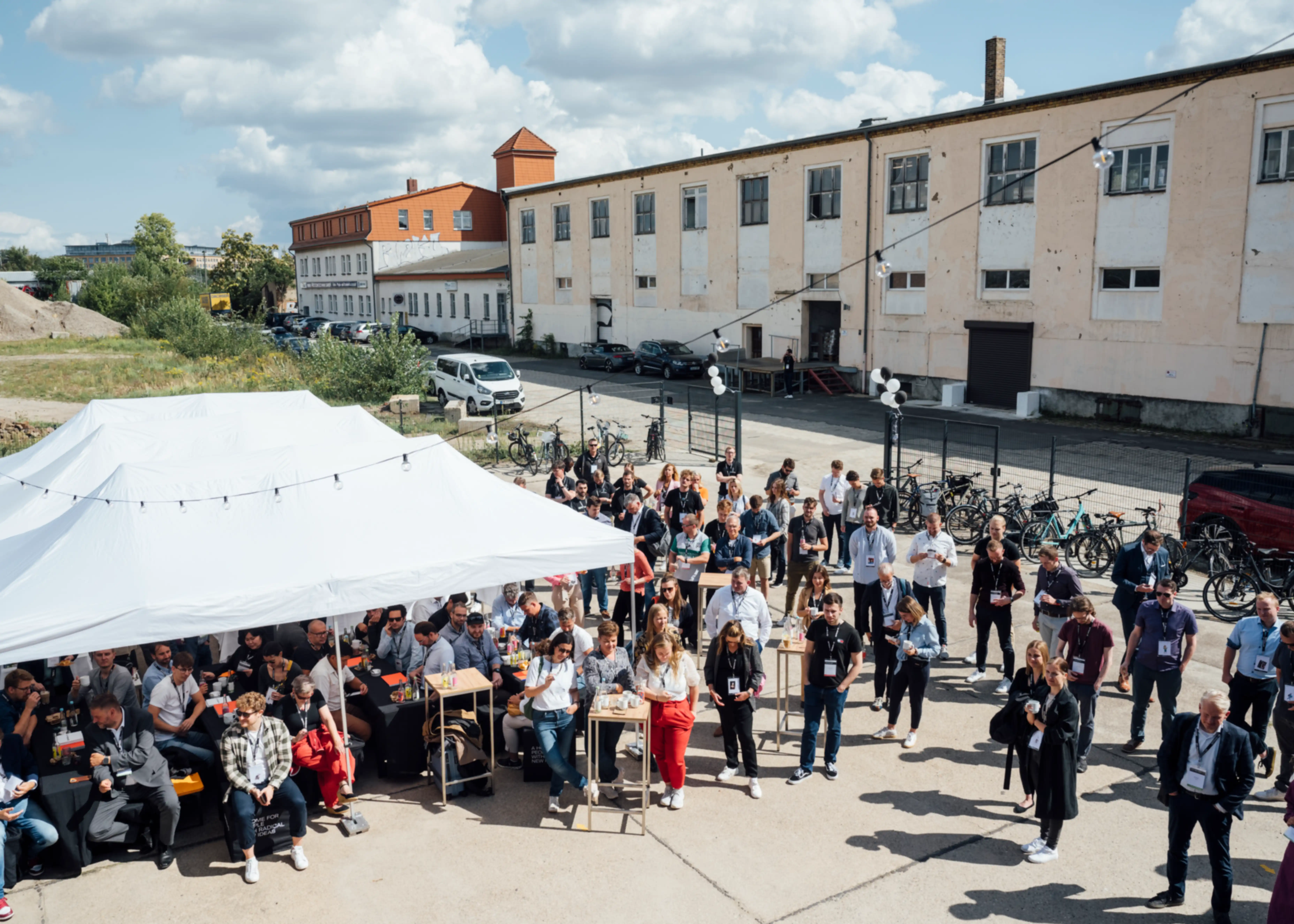 Many people in the outdoor area of the courtyard party, viewed from above